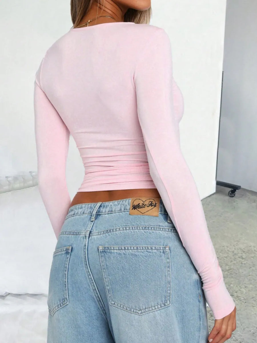 Blush pink long sleeve ruched crop top with a crew neck.