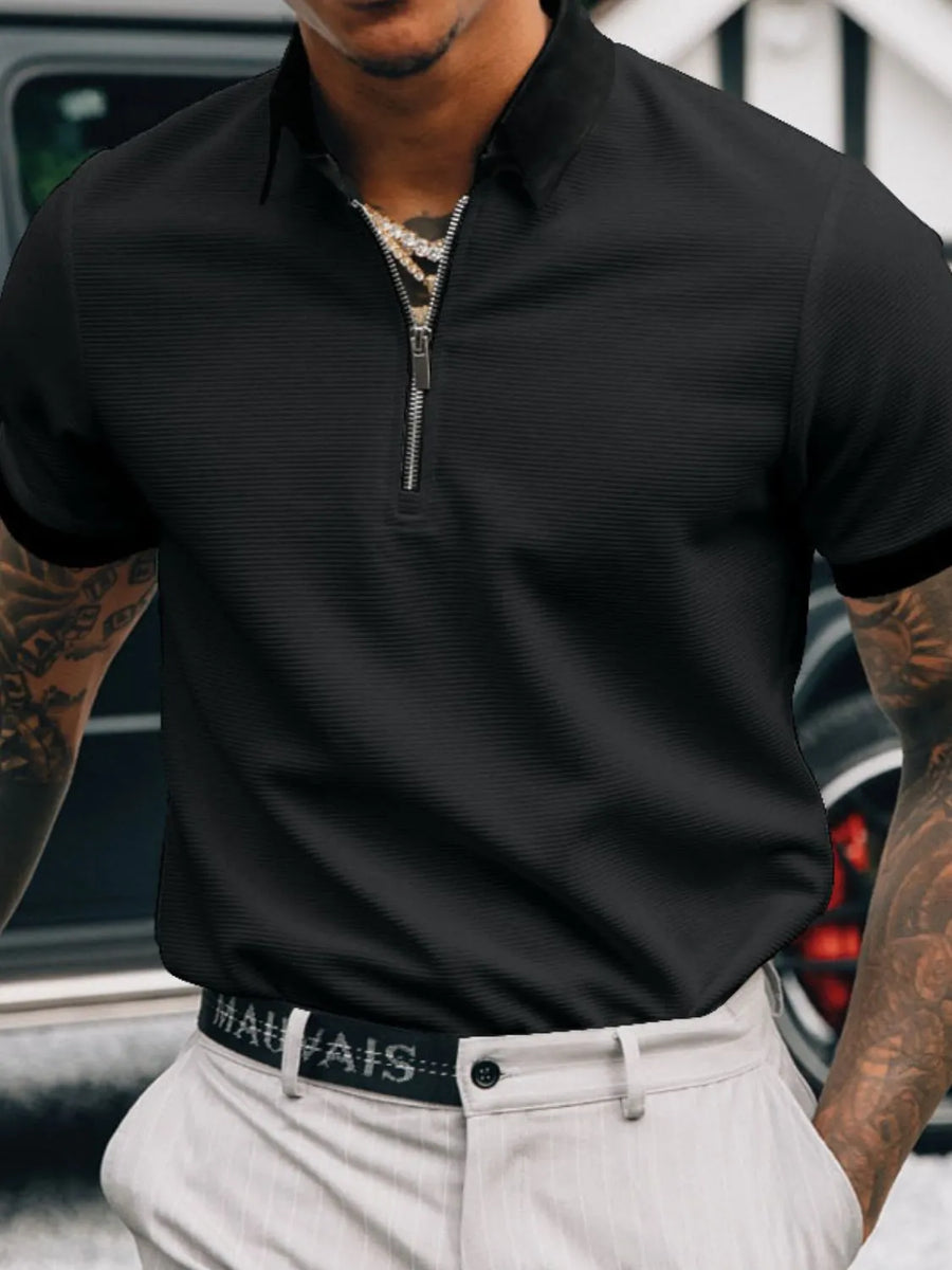 Black textured zip-neck polo shirt with short sleeves and a collared neckline.