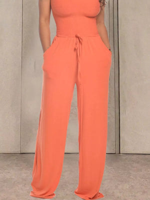Orange smocked wide-leg jumpsuit with drawstring waist and pockets