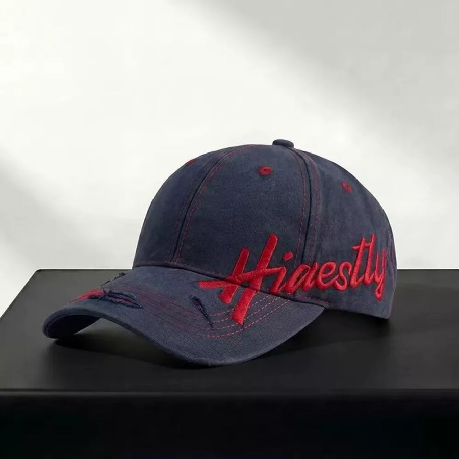 Navy cotton baseball cap with red "Honestly" embroidery and distressed details.