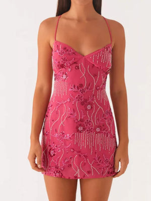 Fuchsia pink mini dress with floral embroidery and beaded fringe detail.