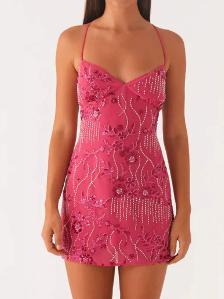 Fuchsia pink mini dress with floral embroidery and beaded fringe detail.