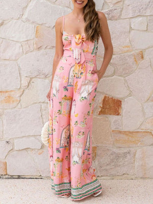 Pink architectural print tie-front wide-leg jumpsuit with bow detail and ornate pattern.