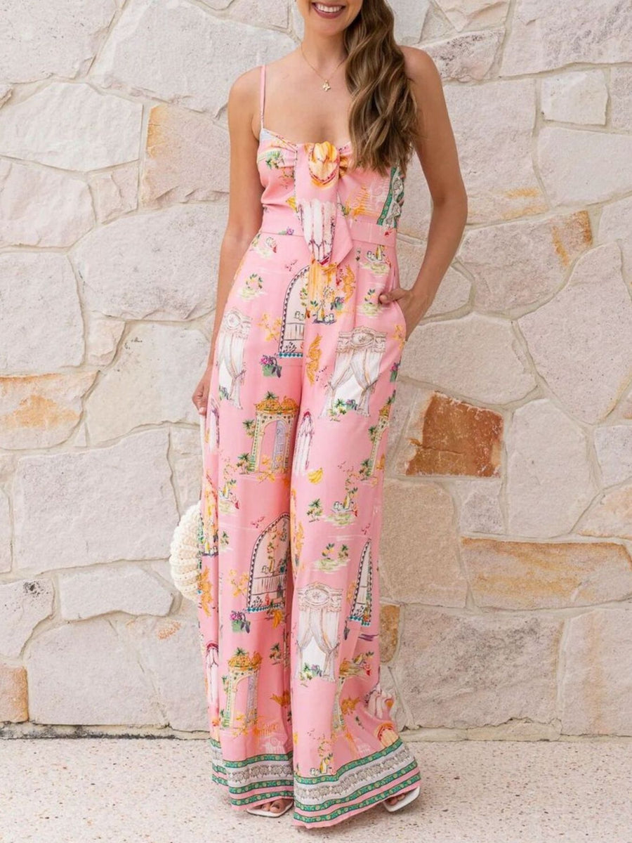 Pink architectural print tie-front wide-leg jumpsuit with bow detail and ornate pattern.