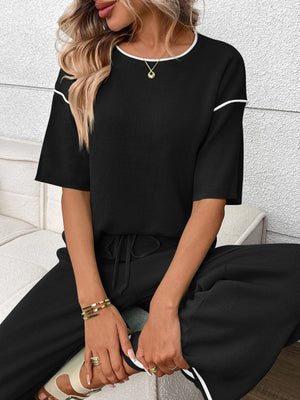 Black loungewear set with crew neck top and drawstring pants, white trim detail