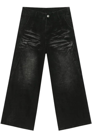 Faded black palazzo jeans in distressed denim with a wide leg.