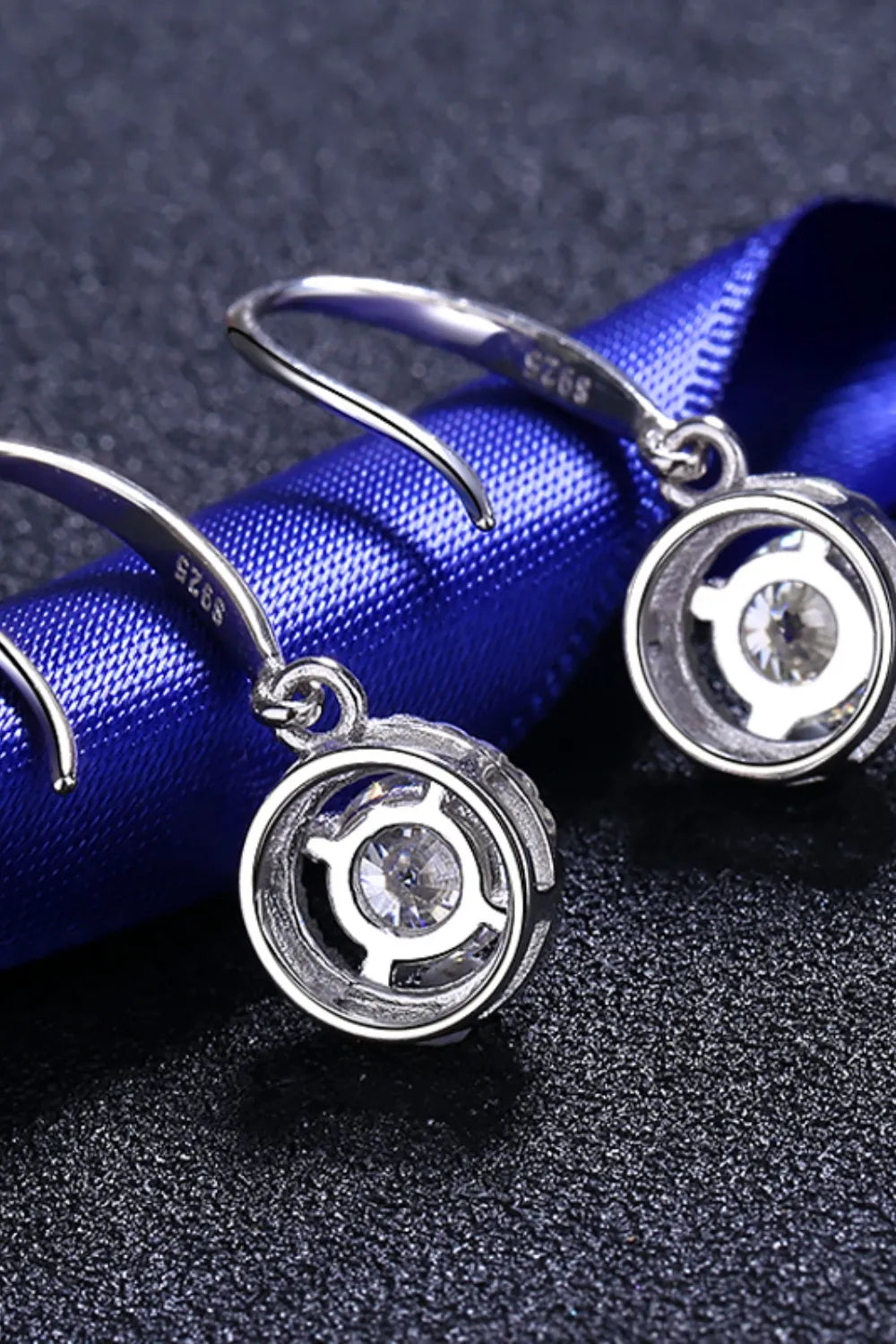 Silver moissanite halo drop earrings with a circular design and clear stone.