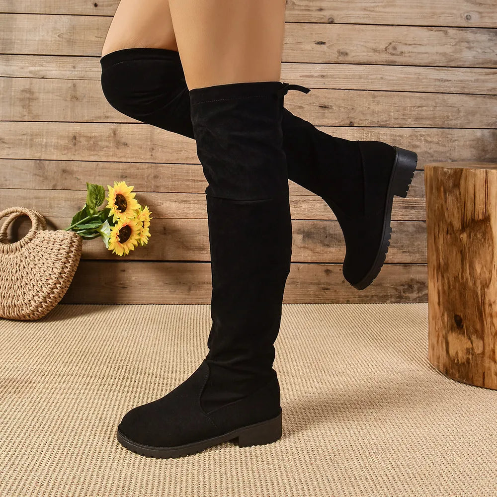 Black suede over-the-knee boots with tie-back detail.
