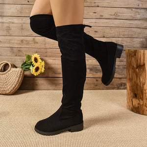 Black suede over-the-knee boots with tie-back detail.
