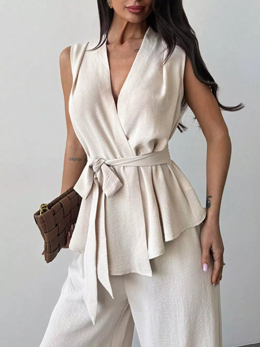 Sleeveless wrap top and wide-leg pants set in beige polyester with tie waist and V-neck.