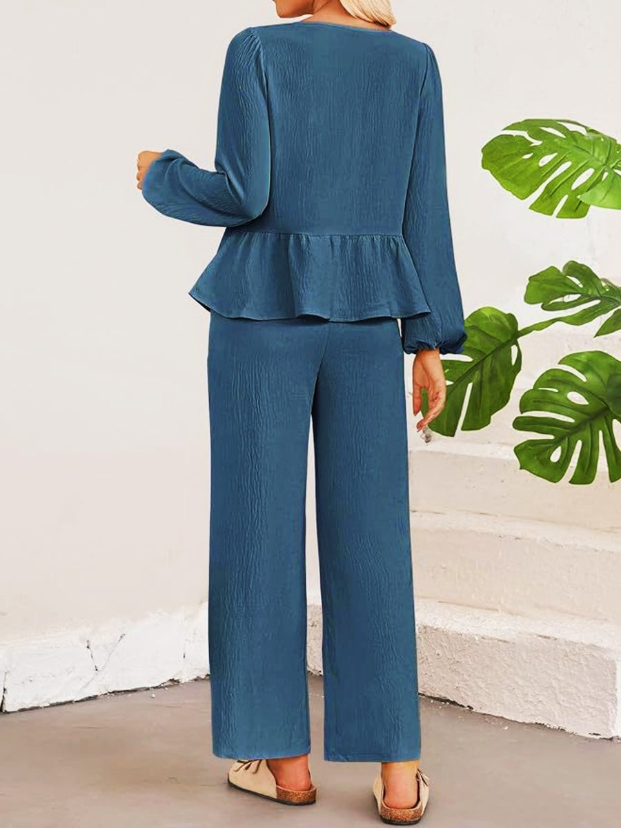 Blue peplum top with long sleeves and wide leg pants