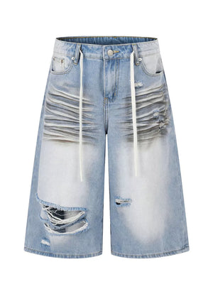 Men's light wash distressed wide-leg capri jeans with drawstring and ripped details.