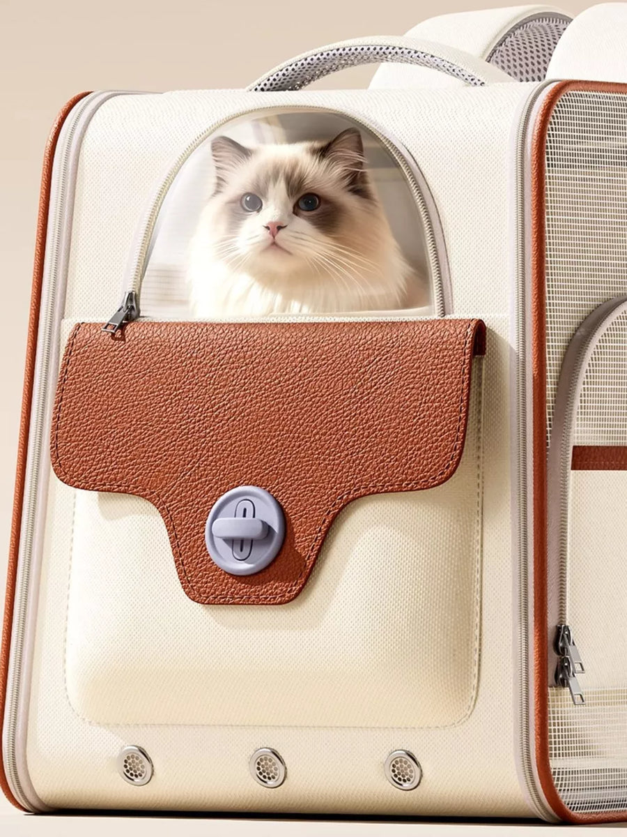 Chic two-tone pet carrier backpack in cream and brown with a cat peeking out.