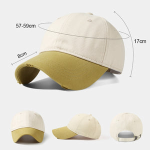 Distressed two-tone baseball cap in tan and khaki cotton with curved brim.
