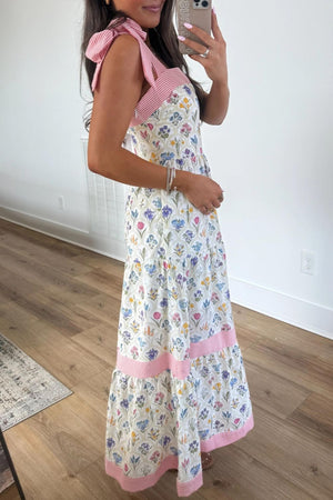White floral maxi dress with pink striped tie straps and tiered skirt
