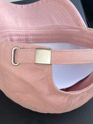 Pink cotton baseball cap with adjustable strap and metal buckle detail