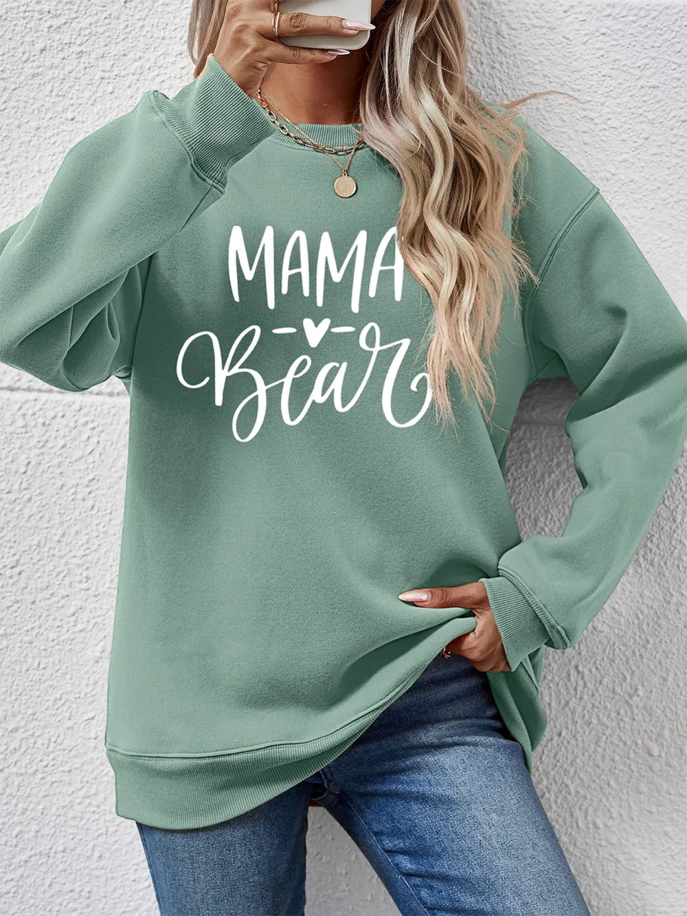 Sage green Mama Bear graphic sweatshirt with crewneck and long sleeves.