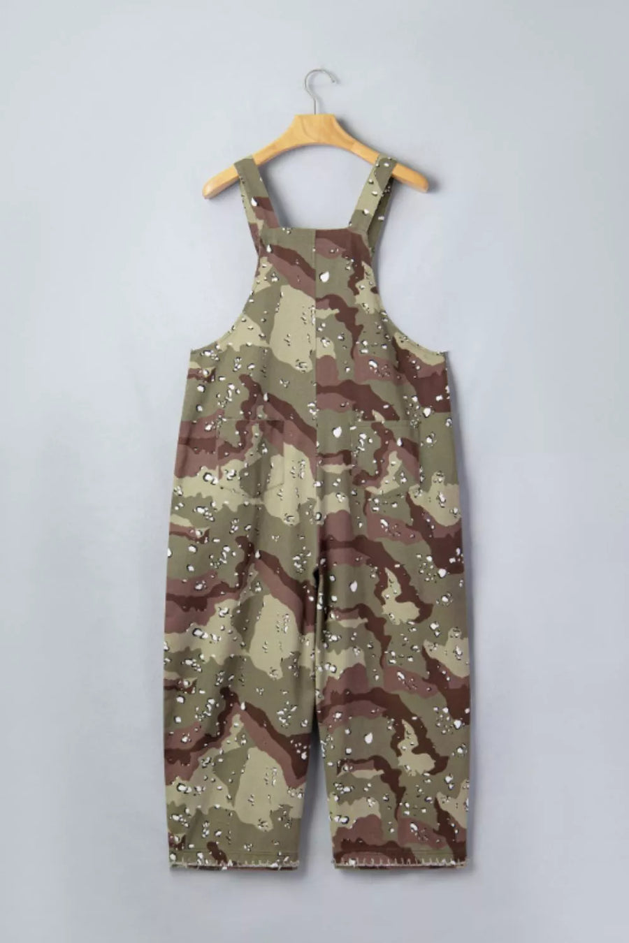 Cropped denim overalls with camouflage pattern and white speckle accents.