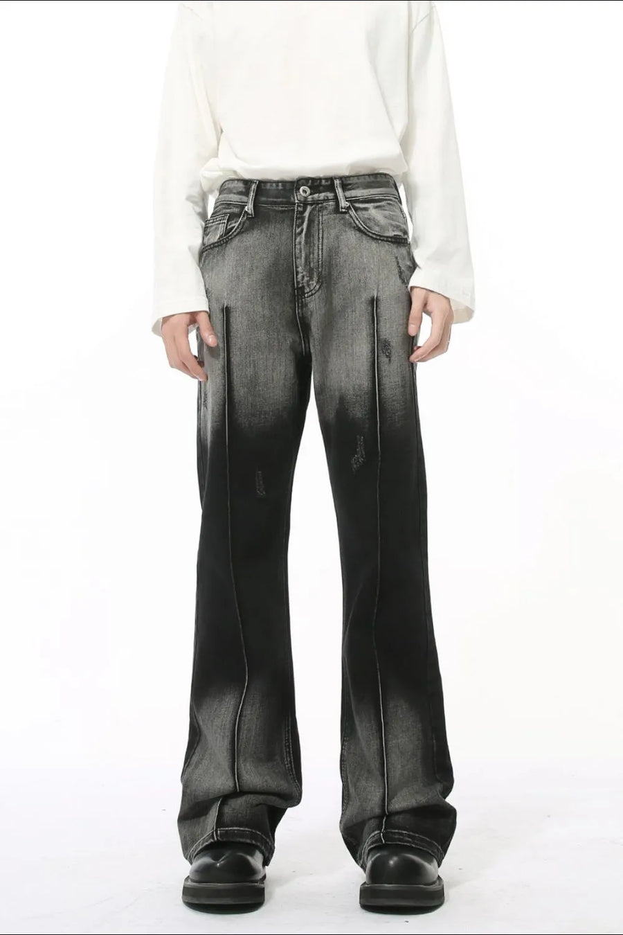 Faded flare jeans in dark wash denim with front pleat detail and distressed accents.