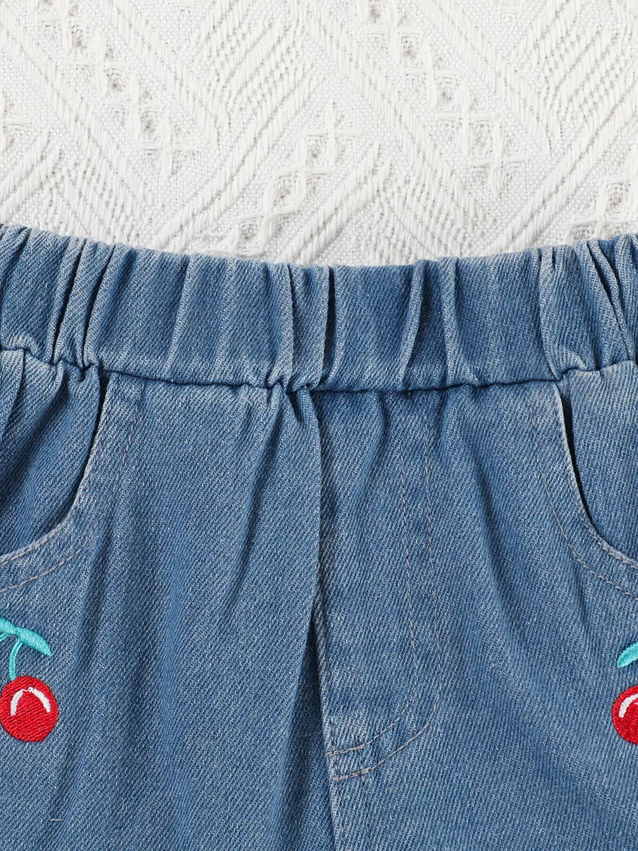 Baby denim shorts with elastic waist and cherry embroidery detail.