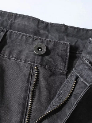 Distressed charcoal wide-leg sweatpants with paint splatter detail, showing button and zipper closure.