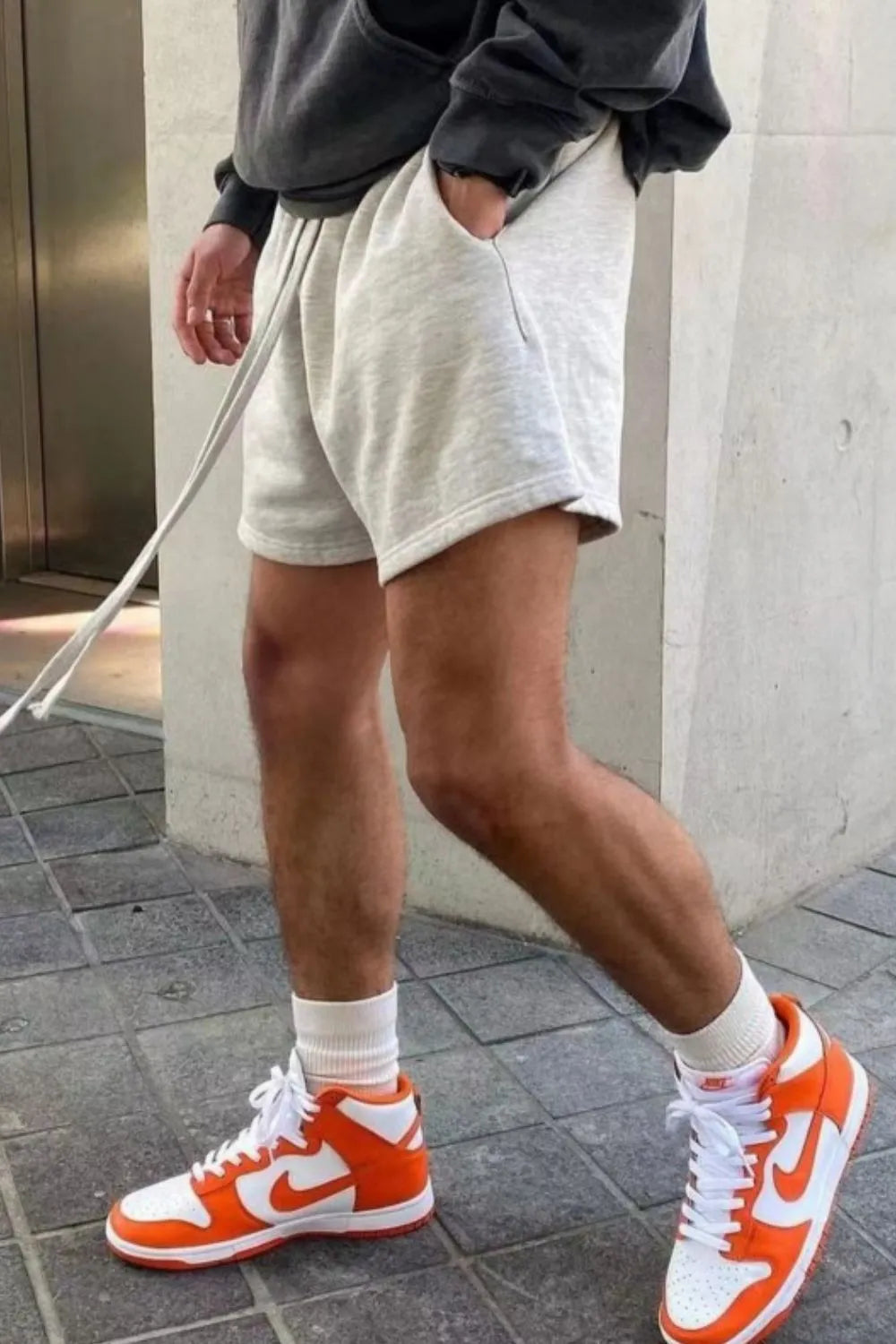 Light gray fleece drawstring jogger shorts with pockets and a relaxed fit.
