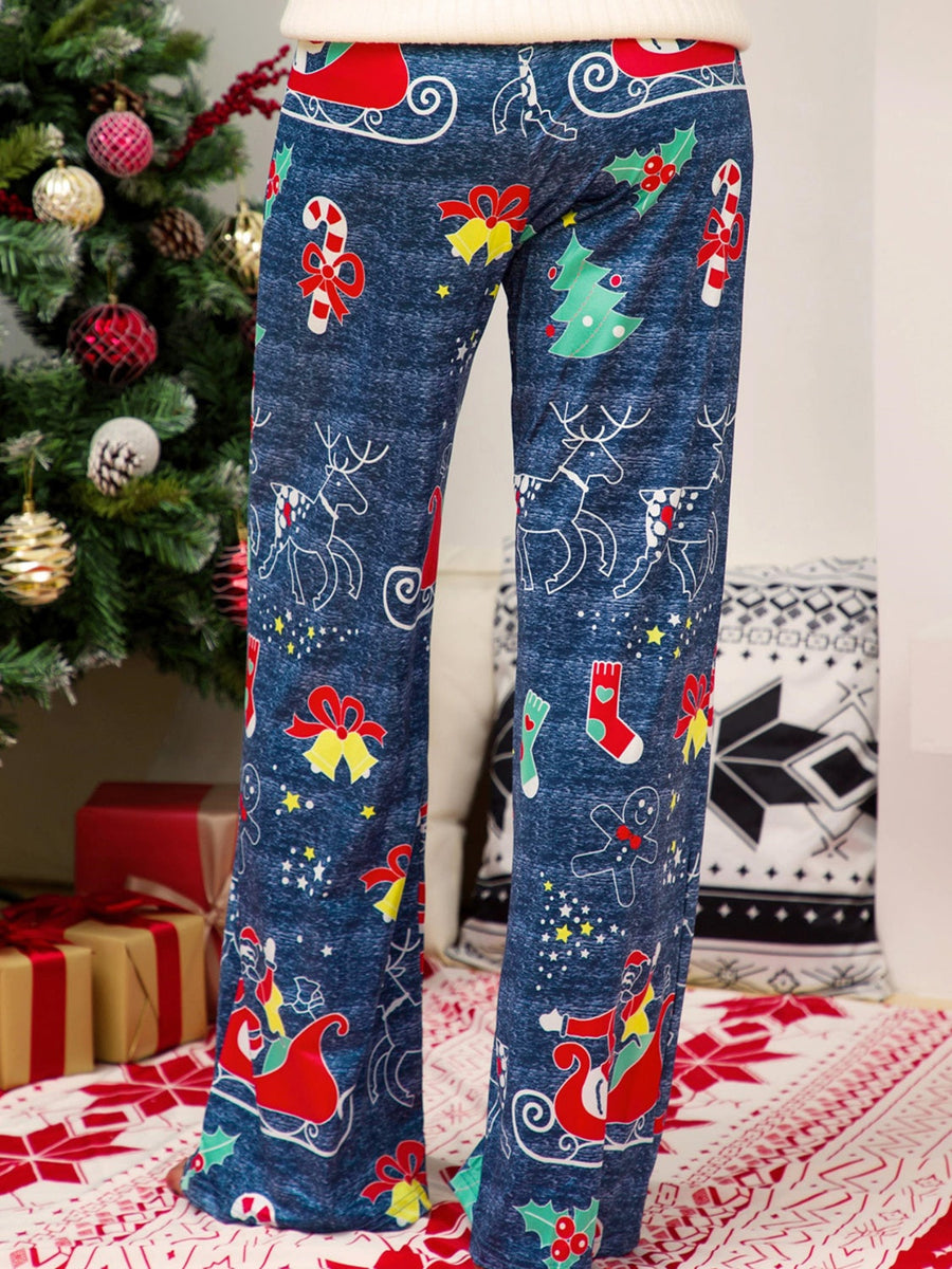 Festive print wide-leg lounge trousers in blue with Christmas motifs like reindeer, sleighs, and candy canes.