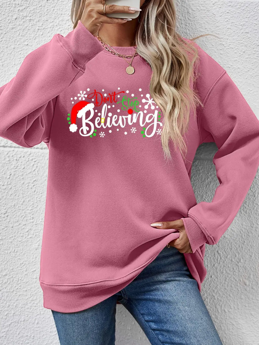 Blush pink long sleeve sweater with a Christmas graphic and crew neck.