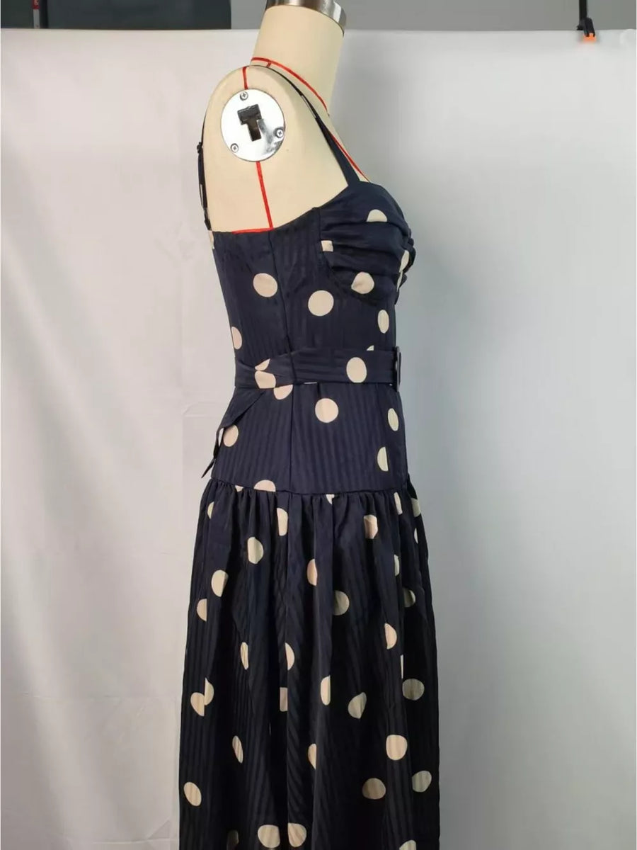 Black polka dot A-line midi dress with sweetheart neckline and belted waist.