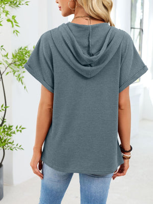 Blue gray waffle knit short sleeve hooded top with cuffed sleeves.