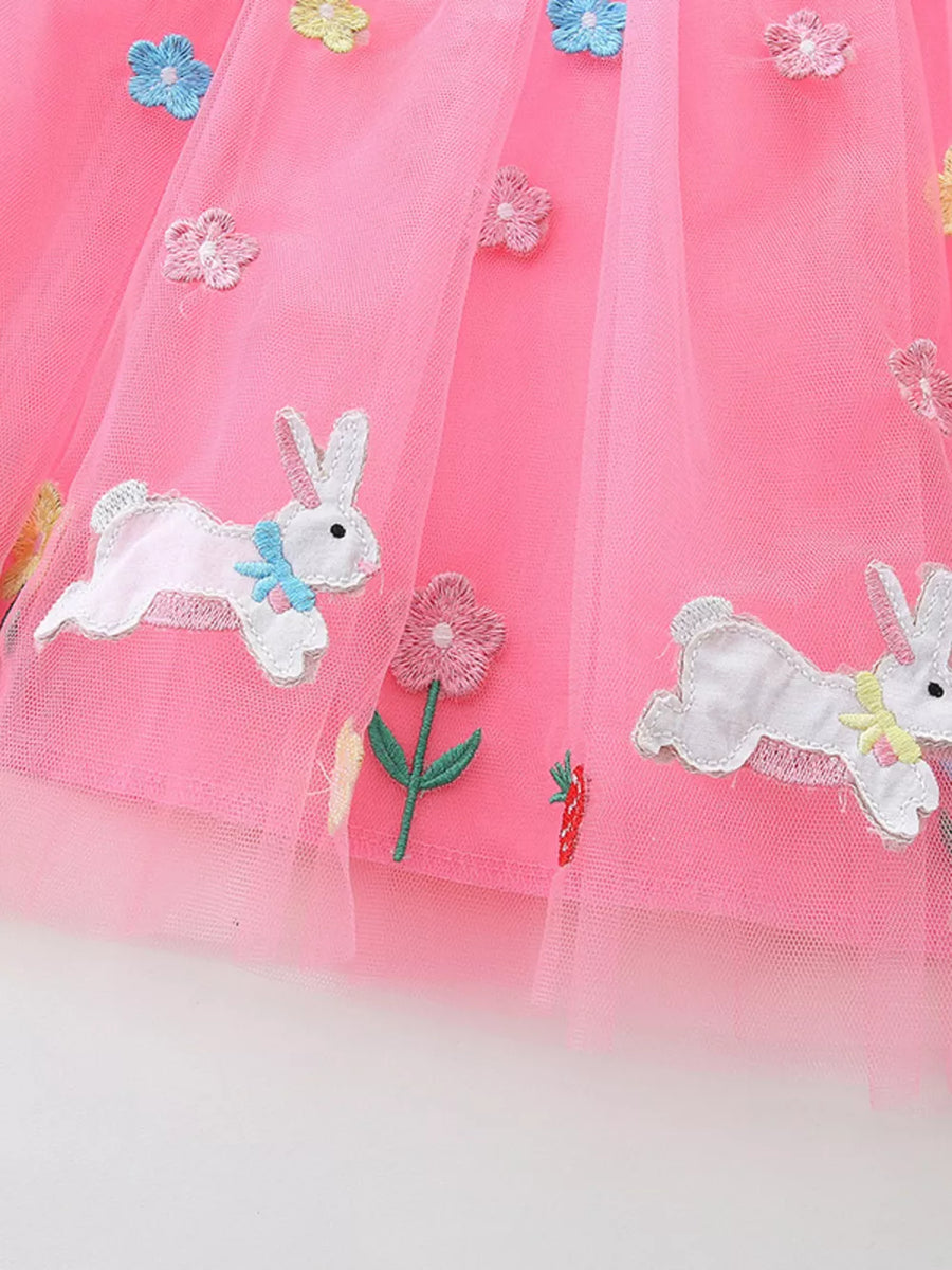 Pink tulle baby dress with embroidered bunny and flower details.