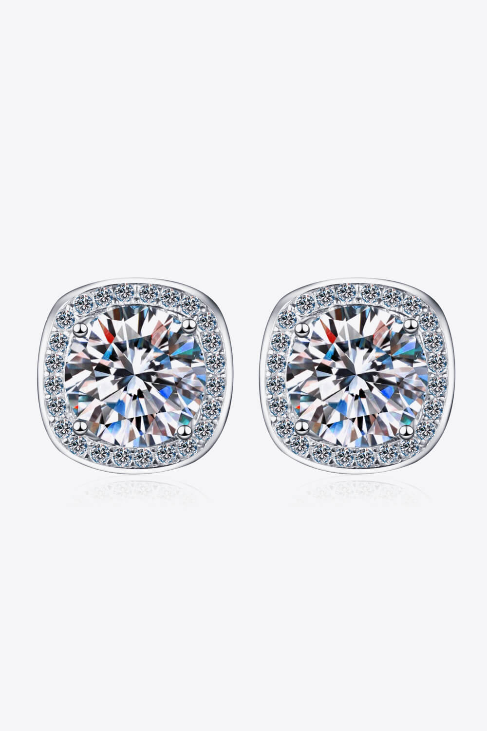 Silver cushion cut halo moissanite stud earrings with sparkling accents.