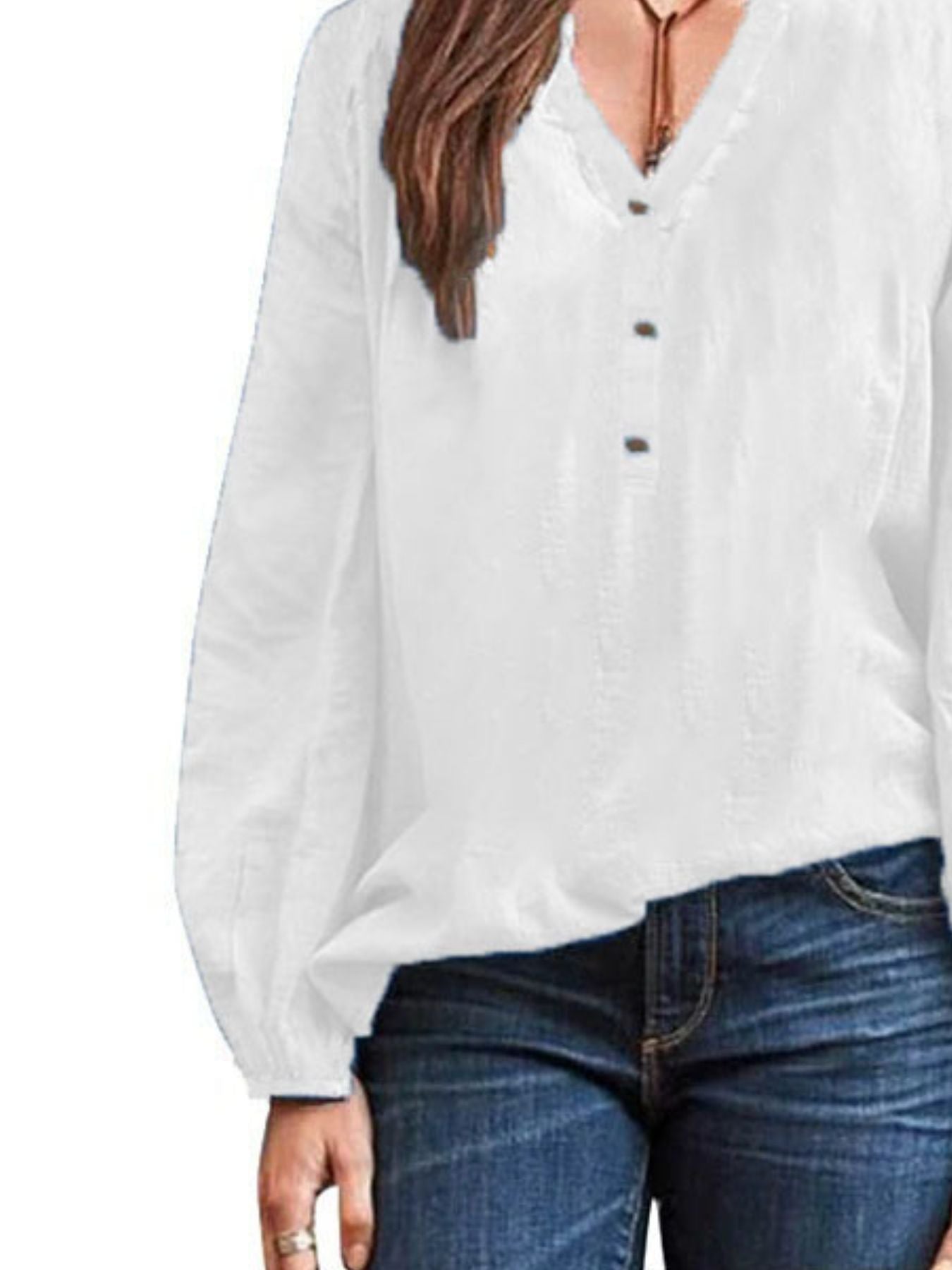 White long-sleeve blouse with notched neckline and button detail
