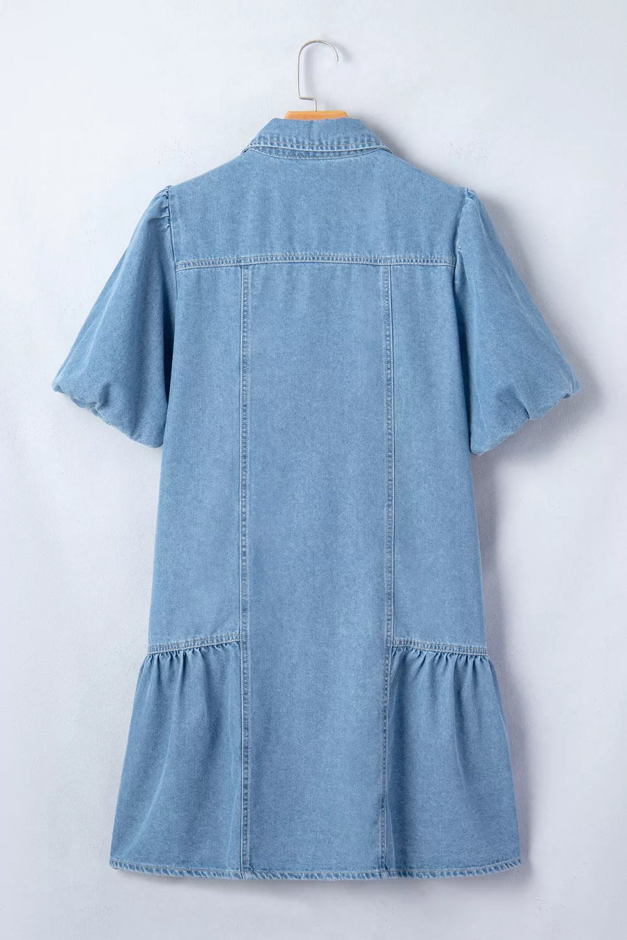 Light blue denim dress with puff sleeves, ruffled hem, and button front detail.