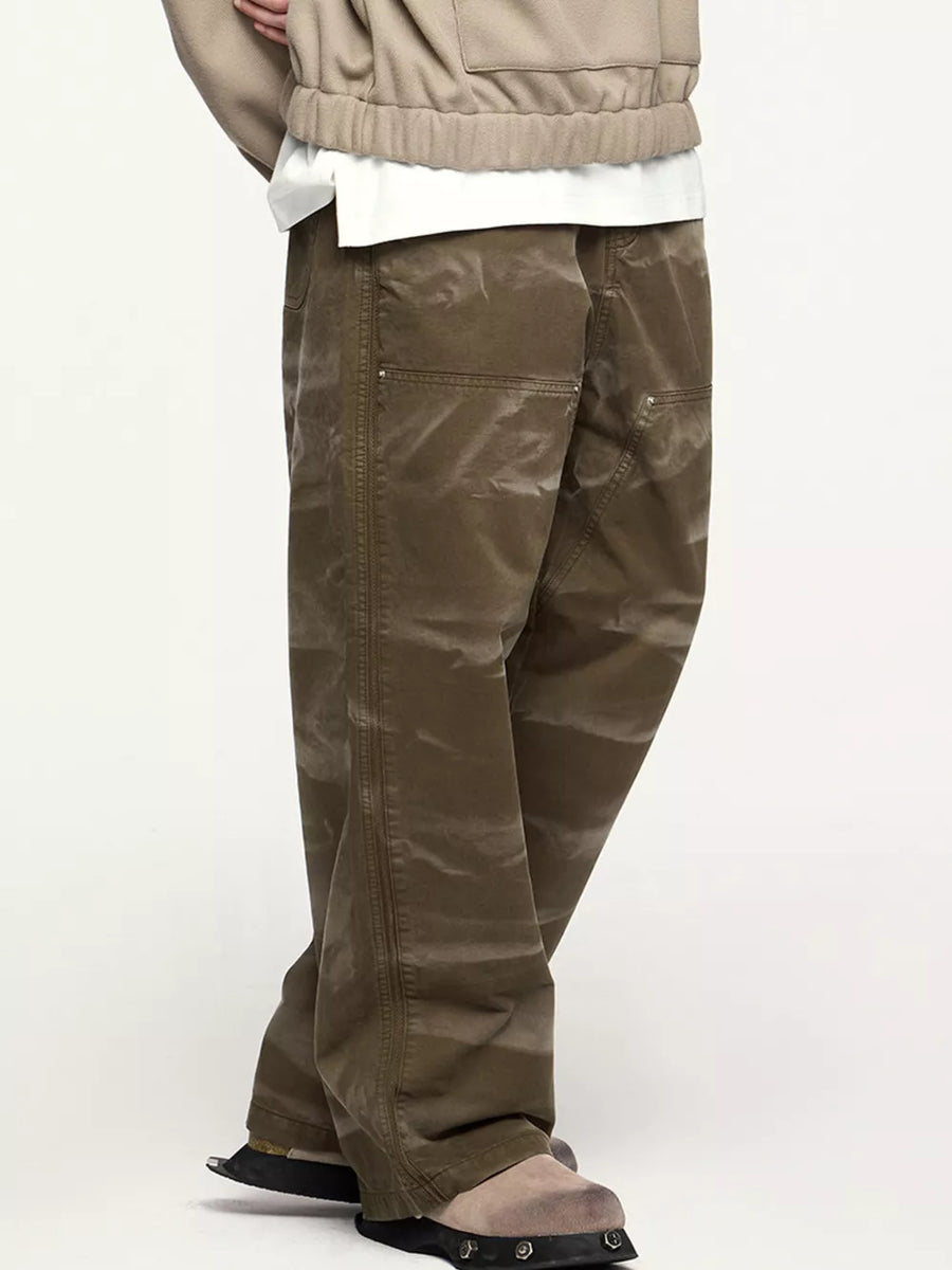 Men's brown cotton cargo pants with a pocketed design and a relaxed fit.