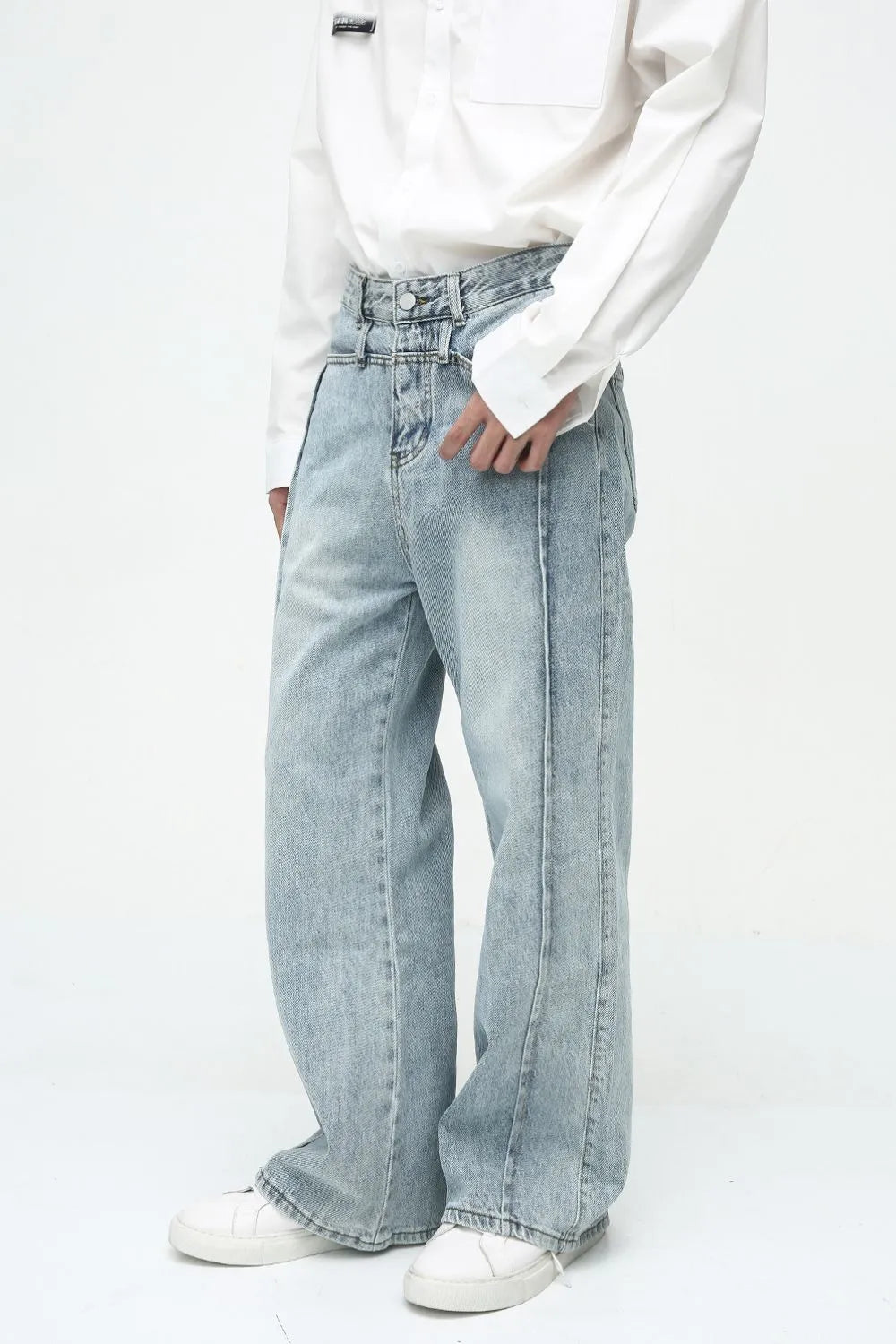 Medium wash denim wide-leg jeans with vertical seams and a high waist.