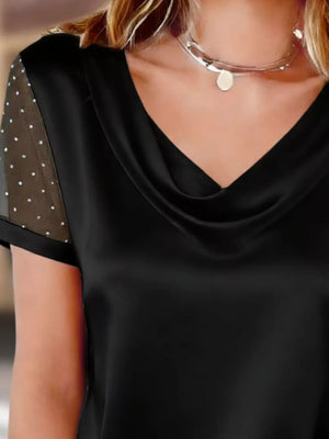 Black cowl neck blouse with sheer sleeves embellished with rhinestones.