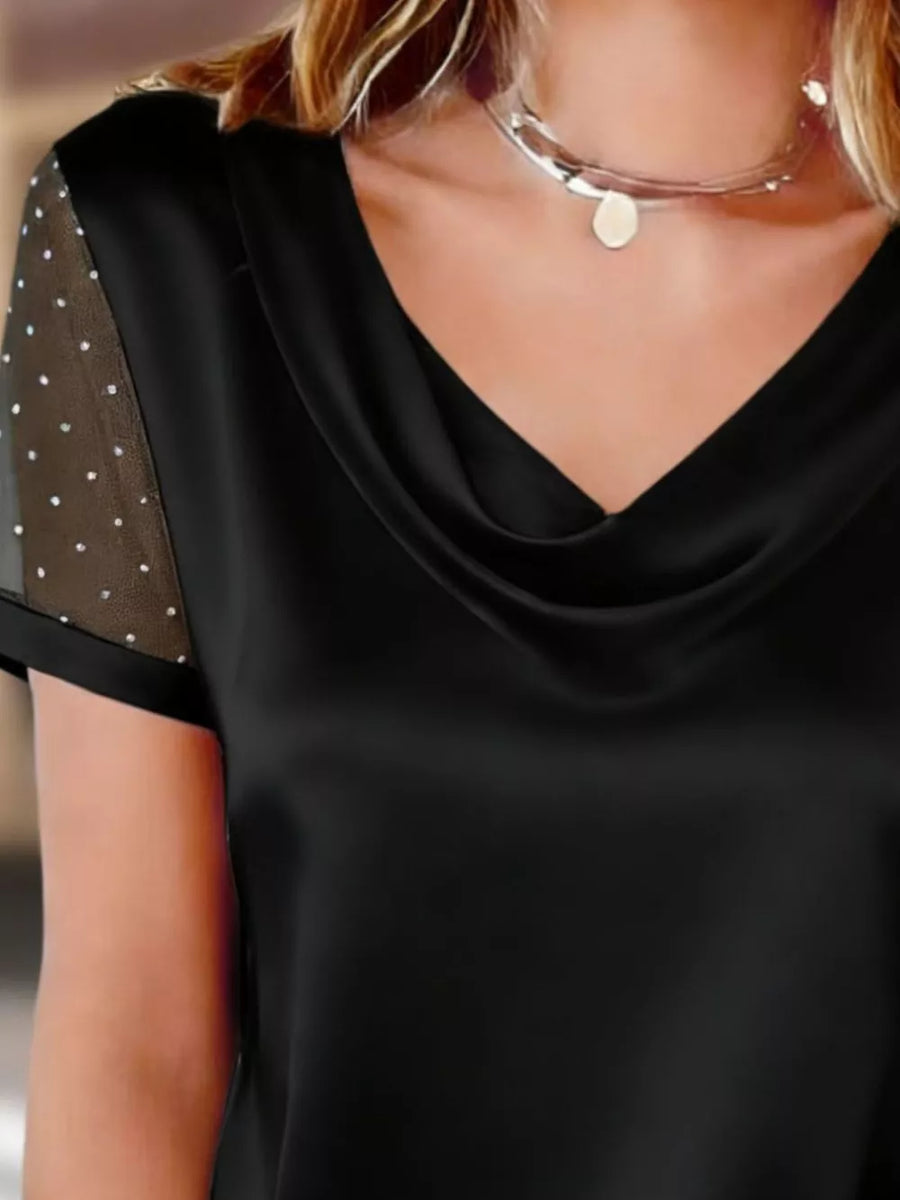 Black cowl neck blouse with sheer sleeves embellished with rhinestones.