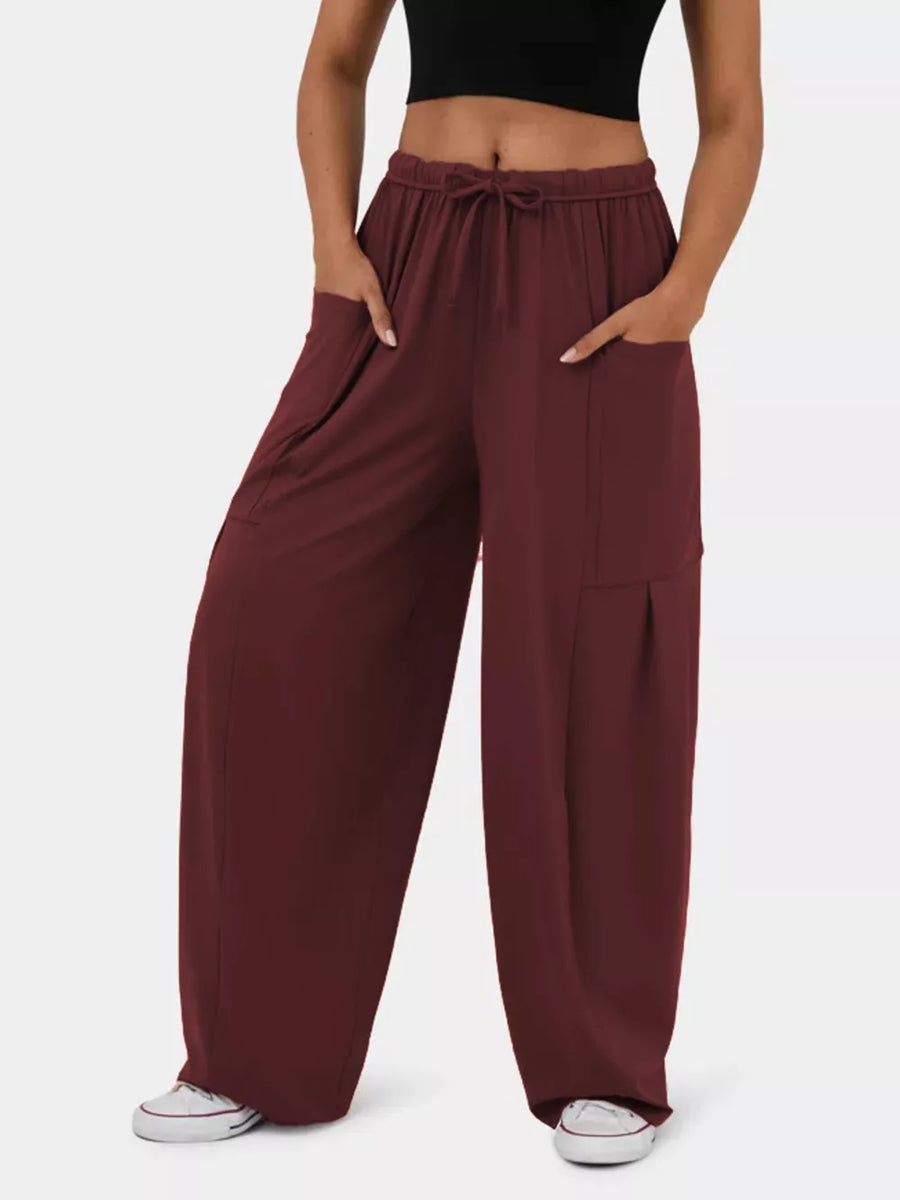 Burgundy maternity pants with adjustable drawstring waist and wide legs.