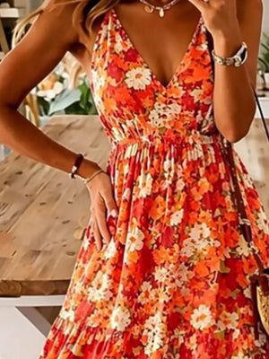 Floral tiered maxi dress with spaghetti straps in orange.