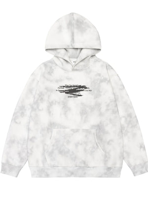 Oversized tie-dye hoodie in Cement Gray with graphic text and front pocket.