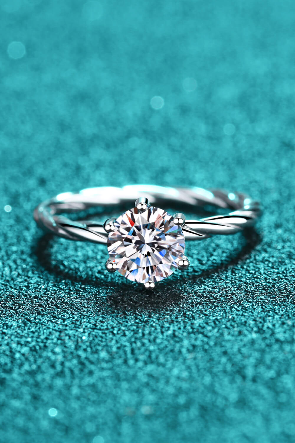 Silver twisted band ring with a round moissanite solitaire diamond.