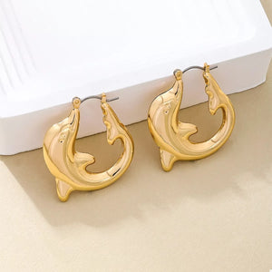 Gold dolphin hoop earrings with a sleek, polished finish.