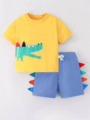 Yellow cotton tee with crocodile appliqué and blue shorts with colorful spikes.