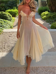 Sheer yellow slip dress with floral bust detail and lace-up front.