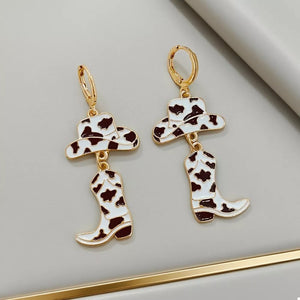 earrings in white with cow print and dangle