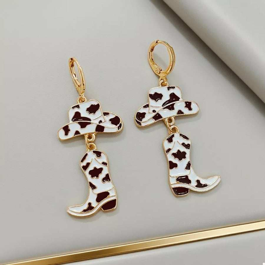 earrings in white with cow print and dangle