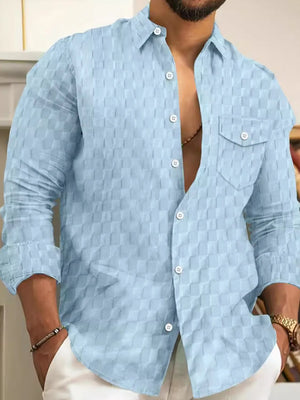 Light blue textured cotton button-up shirt with a checkered pattern and two chest pockets.