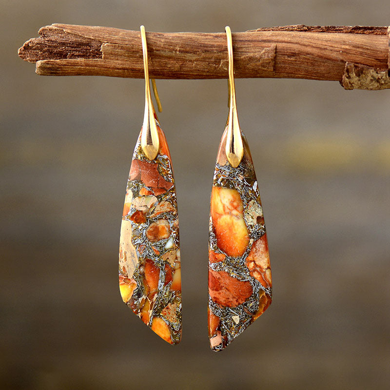 Marbled stone and gold dangle earrings with orange and tan natural stone patterns.