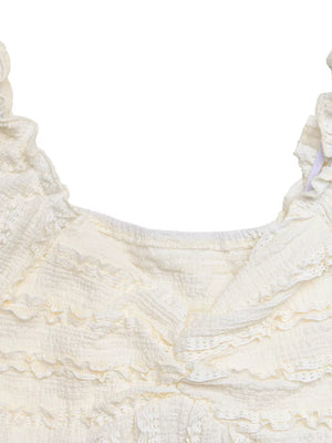 Cream textured maternity t-shirt with ruched front and ruffled neckline.